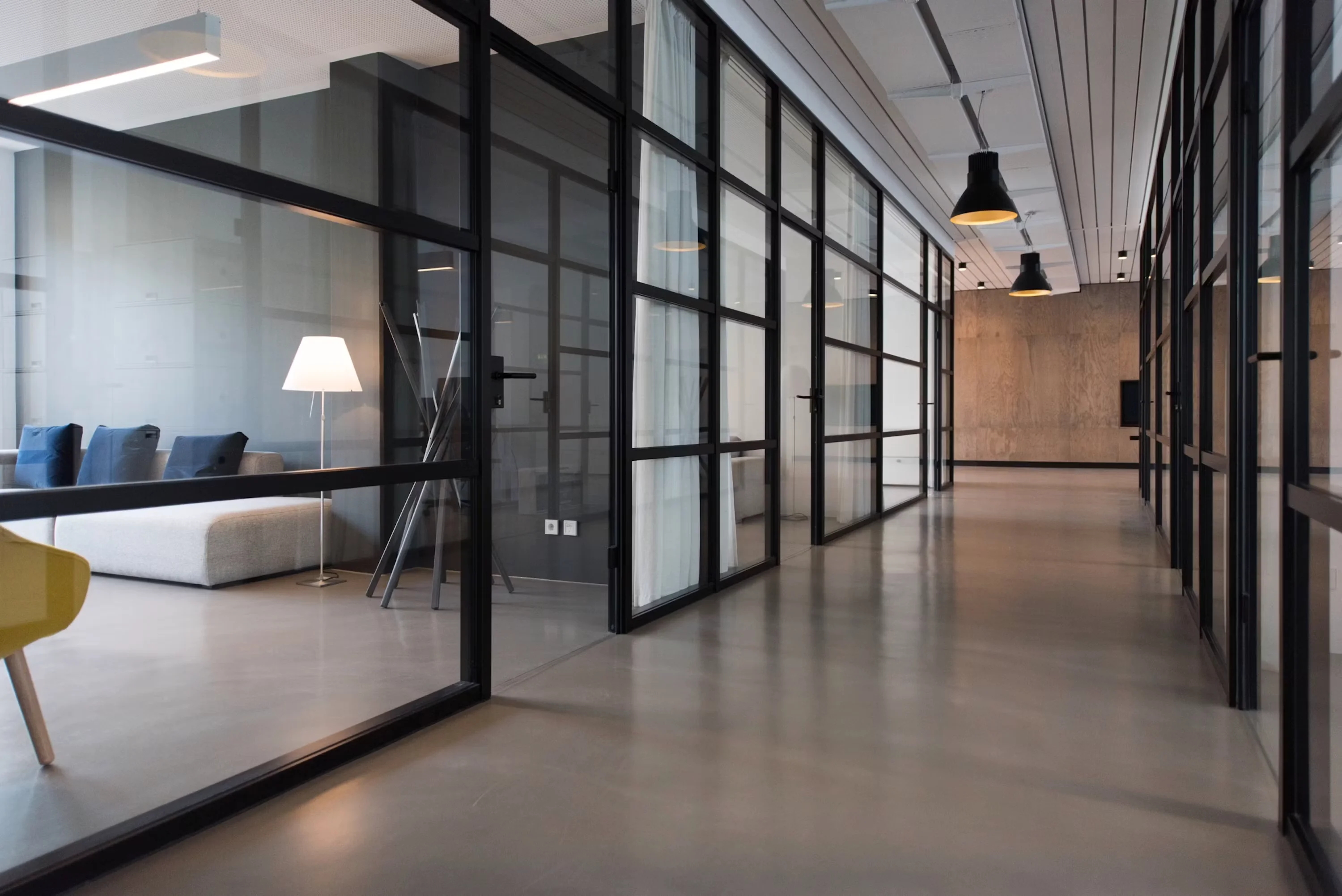 Glass meeting rooms and office corridor