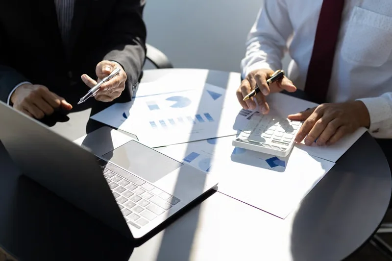 Advisers reviewing business documents together